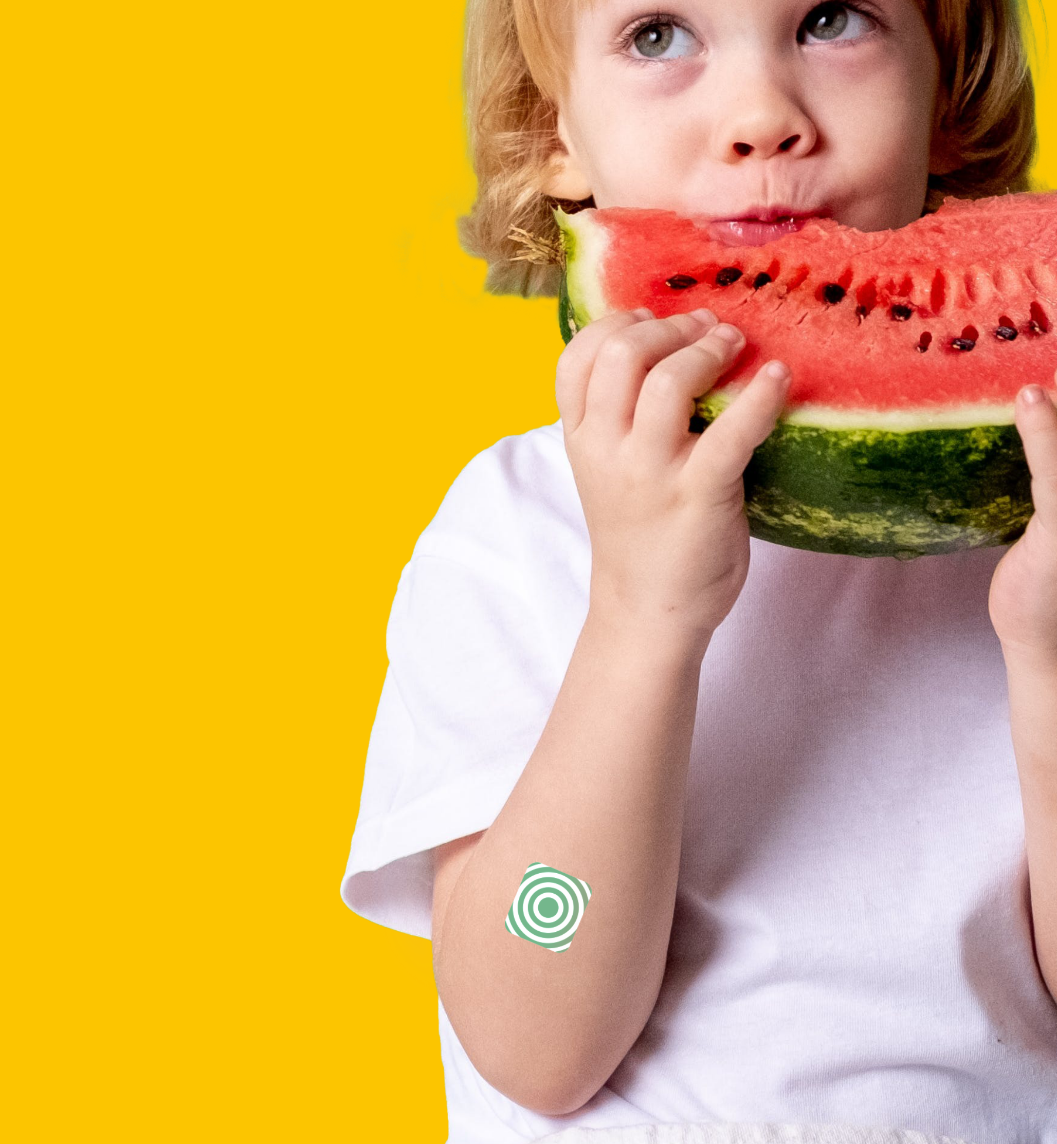 Boy eating watermelon and using his Vitamini vitamin patch made for kids